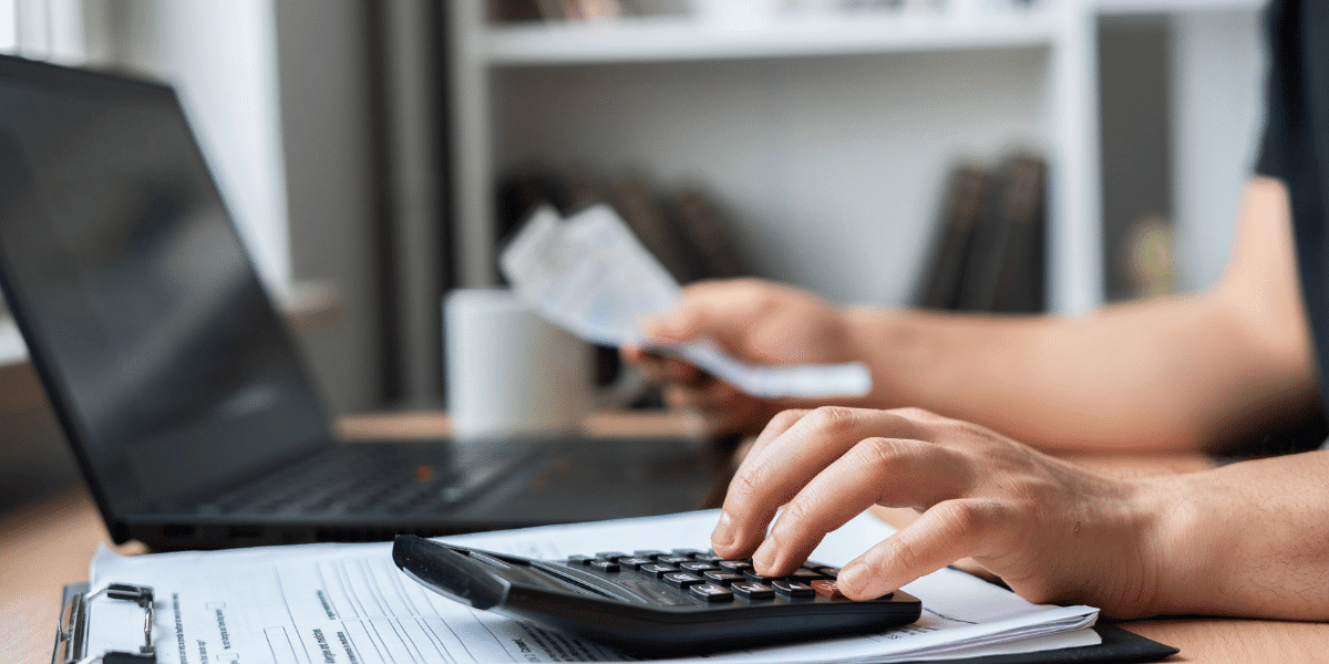 A title agent adding up closing costs.